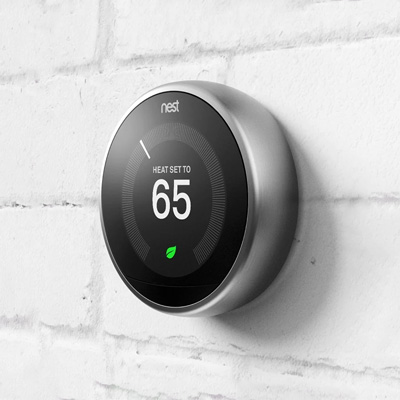 nest smart thermostat on wall